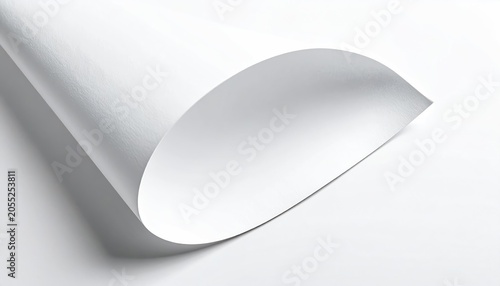 Close-up of a curled sheet of white paper, showing a curved edge and reflective surface. The paper rests against a white background