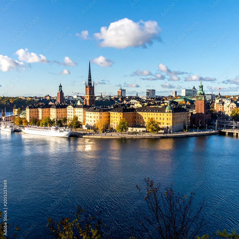Obraz premium Historic Stockholm Skyline Stretching Along Calm Waterfront Under Blue Sky