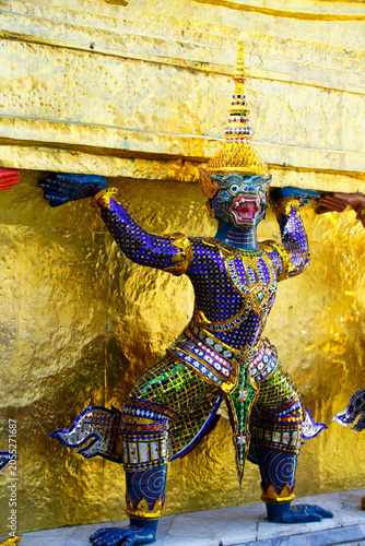 Ornate Mythical Guardian Statue with Glittering Details Supporting Golden Structure