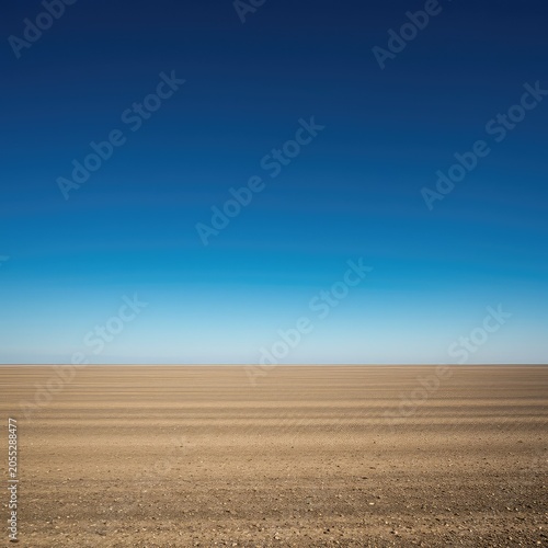Vast open landscape featuring a perfect, clean horizon line separating the deep blue atmosphere and the wide, empty ground plane, clear, empty, infinite