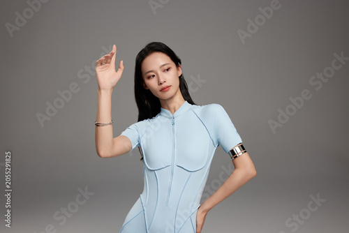 Stylish Woman in Futuristic Blue Bodysuit