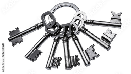 Isolated bunch of shiny antique metal keys on a keyring for unlocking secrets and access.