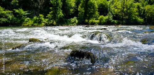 Bild auf Leinwand Close view of sparkling rapids and textured river water in the Kolpa Kupa River