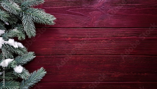 Snowy Spruce Branches On A Dark Maroon Wood Background