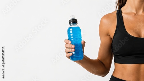 woman holding blue sports drink in black workout top with clean copy space, Middle aged fitness hydration and electrolyte wellness for perimenopause therapy and active lifestyle concept