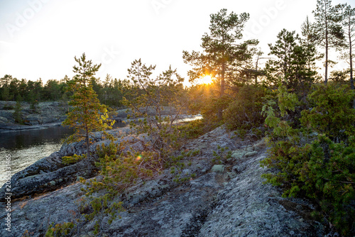 Foto Nature skerry at Lake Ladoga against the background of the setting sun