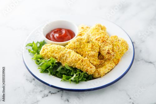 Chicken stipes with tomato sauce