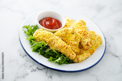 Chicken stipes with tomato sauce