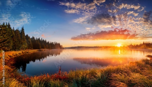 Amazing Sunrise Over Lake With Colorful Clouds At The Horizon Forest On The Lake Side Sunny Morning In Wild Nature