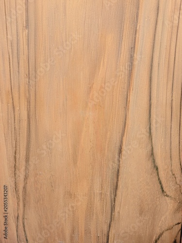 фотографія A close-up shot of a smooth, light brown wooden surface featuring prominent vertical dark grain patterns