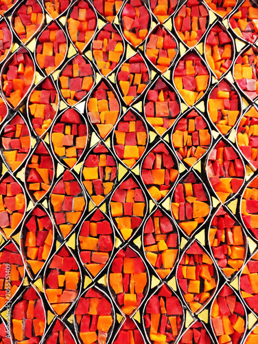 Close-up of a colorful mosaic made of ceramic fragments. Abstract texture, decorative art, handmade craftsmanship, detailed mosaic pattern.