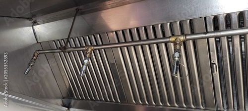 Konstfotografi A close-up of the nozzles and piping of a kitchen fire suppression system