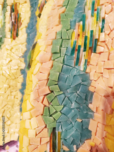 Close-up of a colorful mosaic made of ceramic fragments. Abstract texture, decorative art, handmade craftsmanship, detailed mosaic pattern.