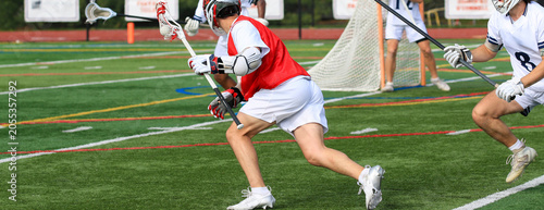 Lacrosse Players in Action During a Game on a Sports Field