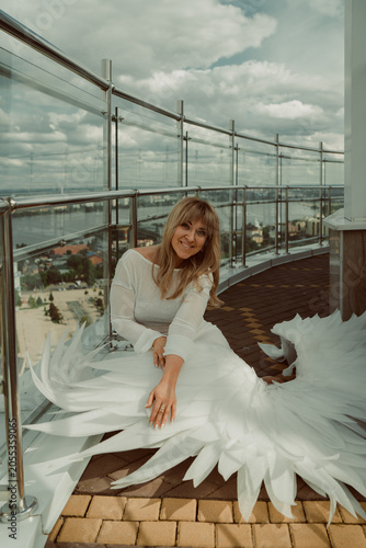 Angel girl with wings on the roof of a building