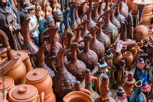 A counter with jugs and ceramic handicrafts made in Georgian national style put up for sale