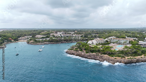Foto Mediterranean coastal town and marina on Mallorca island captured by drone under