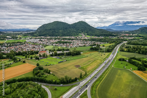 Photography A scenic aerial drone view looking over the Brod district in Ljubljana, Slovenia, with the prominent double-peaked Smarna Gora hill rising in the mid-ground