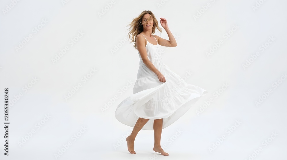 Naklejka premium Happy blonde woman twirling in white dress on isolated background