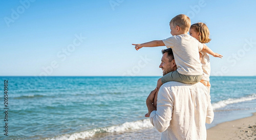 Cuadro en lienzo Cheerful father carrying young son on shoulders while standing on sandy beach sh