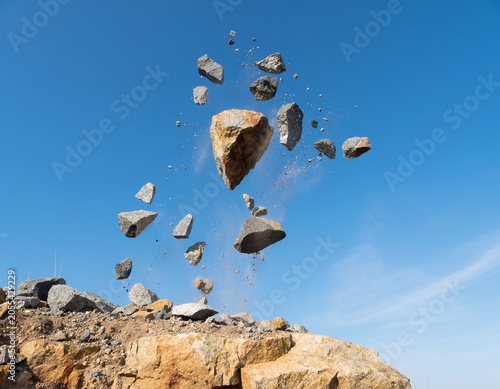 Stones caught mid-exhale as the cliff forgets gravity under a flawless sky