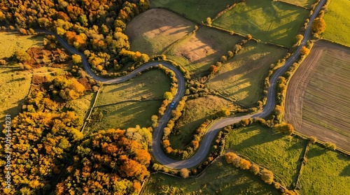 Aerial view of a winding road through autumn landscape