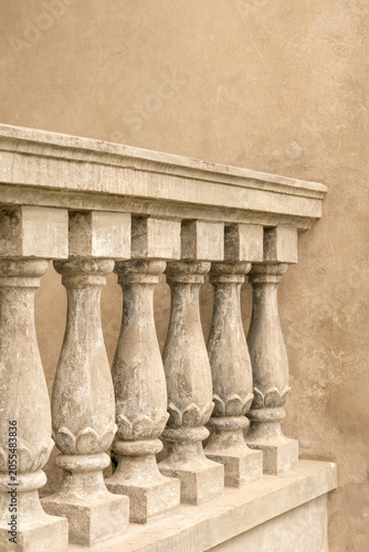 Weathered stone balustrade detail on historic facade
