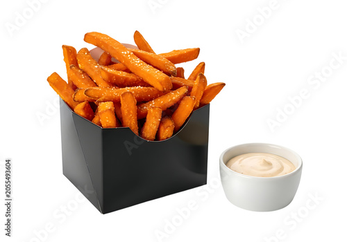 Crispy sweet potato fries in a black paper carton with a side of creamy dipping sauce