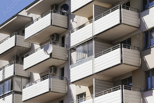 Canvas Print Modern apartment building facade with rows of balconies and air conditioning units