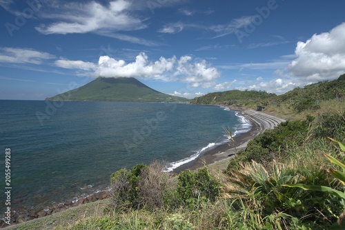 Green coastal headland and cone mountain in summer, Japan