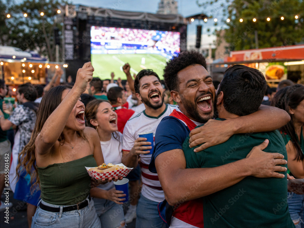 Obraz premium Outdoor Sports Watch Party With City Crowd at Dusk