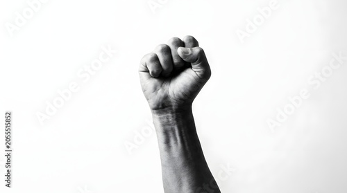 Black and white shot of raised clenched fist symbolizing power revolution resistance victory solidarity