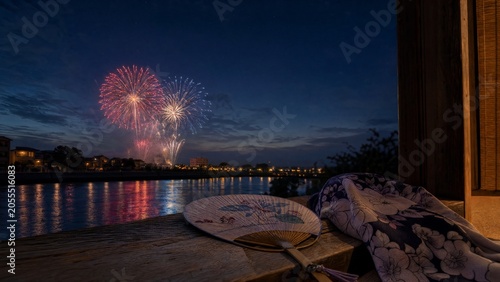yukata. Folded fan and yukata sleeve on doorstep with fireworks over Sumida River, Tokyo summer celebration. event programs, museum guides, designed for cultural heritage projects and event programs.