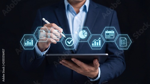 Business professional using digital tablet with analytics icons floating above, showcasing data task and technology workspace for modern business & office