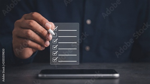 Person selecting checklist items on smartphone screen with stylus, showcasing digital hand and technology checkmark for modern phones & mobile devices