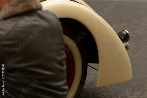 Konstfotografi Tight composition showing the rear wheel and cream-colored fender of a vintage a