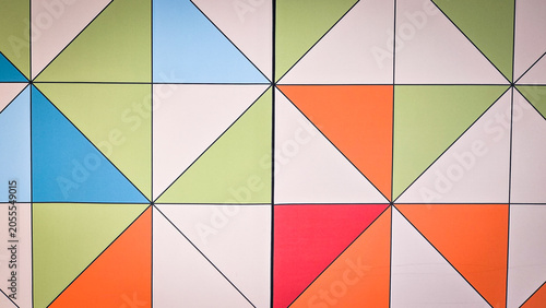 Abstract geometric wall pattern with colorful triangles