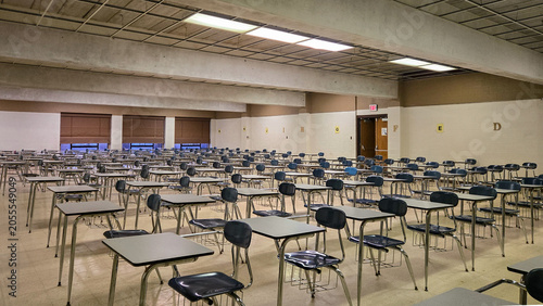 Empty school classroom with rows of desks and chairs