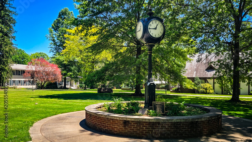 Vintage street clock on a pedestal in a school campus garden