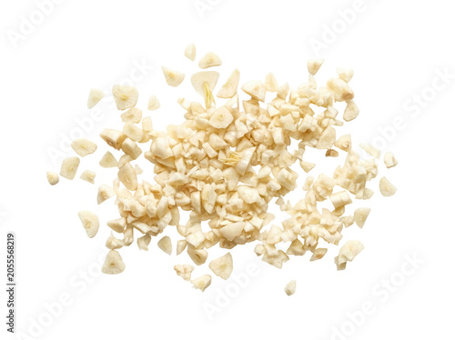 Pile of finely chopped fresh garlic cloves on a white background