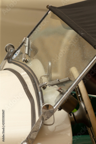 Fotografie Tight detail of a bass drum showing metal tension rods, chrome rim, mallet holder and white drumhead viewed at an angle