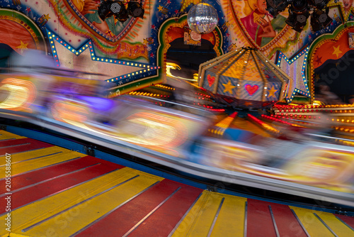 Bild auf Leinwand Amusement park long exposure motion blur carnival ride