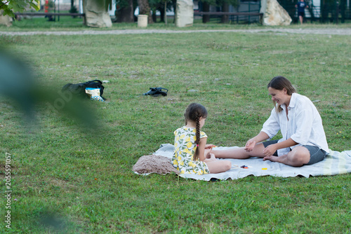 A woman and child enjoy a sunny afternoon playing a game outdoors.