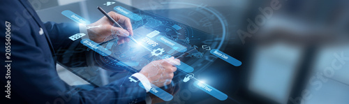 Operations engineer point of DevOps automation. Engineer using tablet deploying software updates across the global production network. Streamlining digital delivery and minimizing downtime.