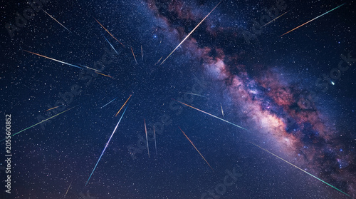 Colorful meteor shower radiating across the night sky. Milky Way galaxy and starry background. Astrophotography of celestial phenomenon