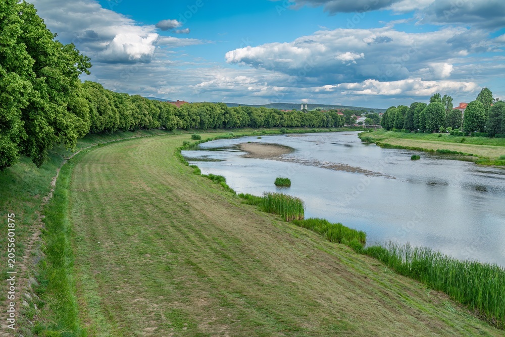 Fototapeta premium Beautiful scenic river landscape winding through green city park embankment
