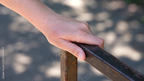 Schilderij op canvas A close-up shot of a woman hand holding onto a rusty metal handrail outdoors