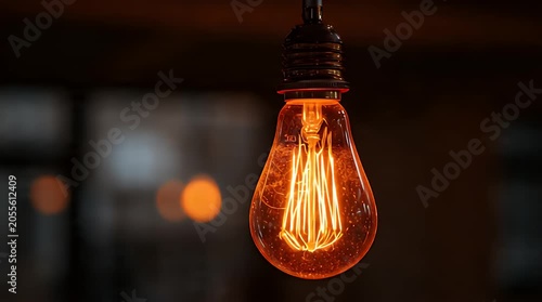 Glowing filament inside an antique Edison-style incandescent bulb, casting warm light