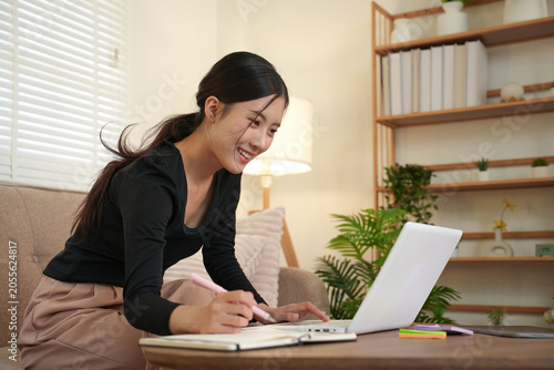 Woman Working on Laptop with Focus at Home