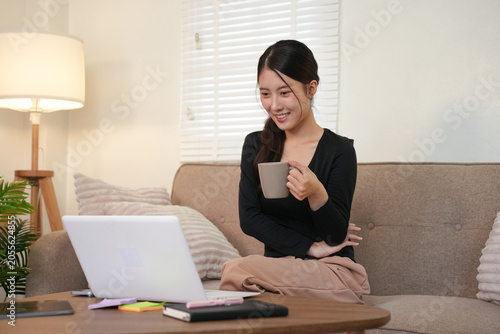 Happy Woman Working Remotely on Laptop